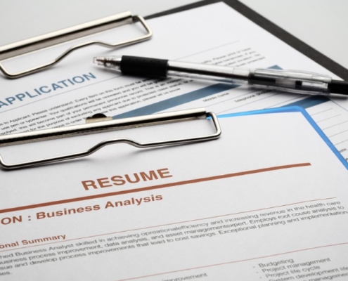 picture of a resume and job application that will undergo education verification by a background check provider
