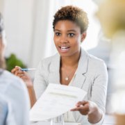 Young woman interviewing with company who has to make hiring decisions